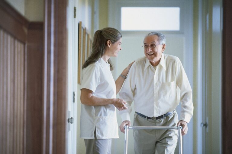 happy resident speaking to a nurse in hallway